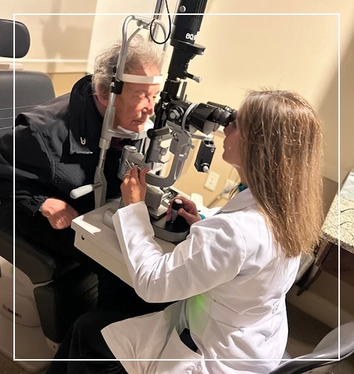 Dr. Sayani doing eye exam elder