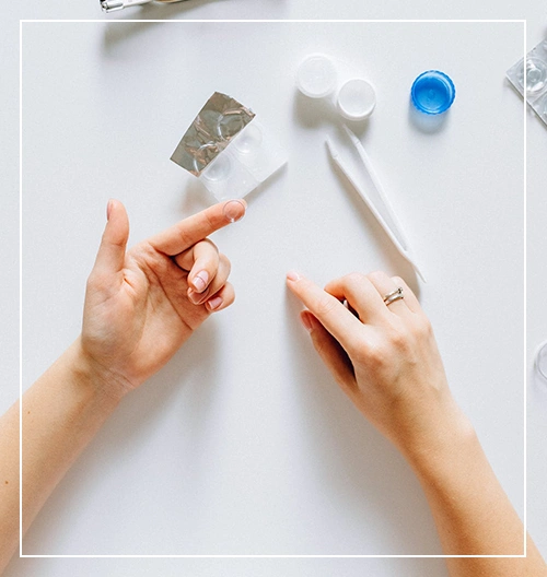 Woman applying contact lenses