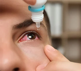 Woman putting in eyedrops